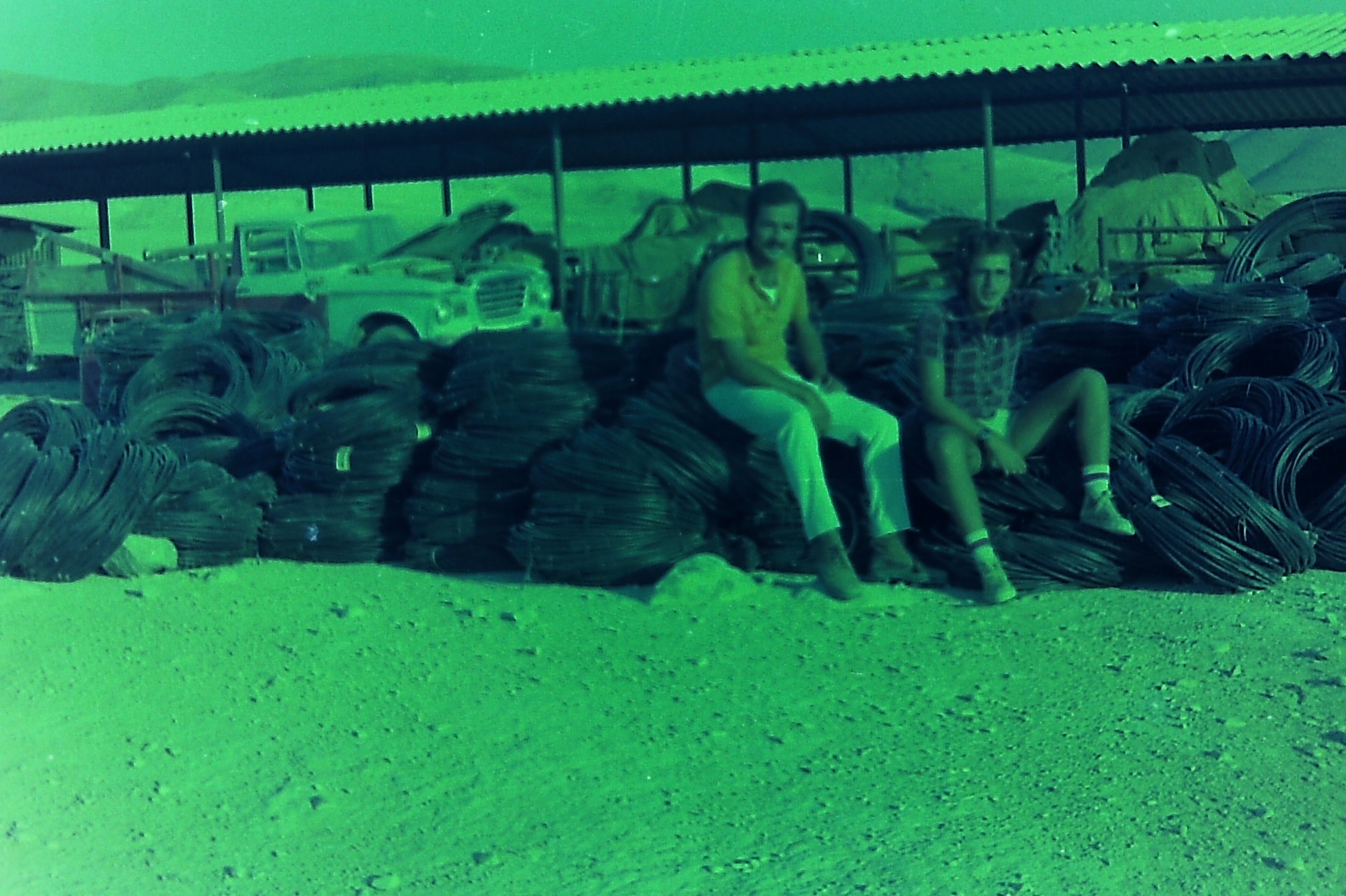 Samsam (left) and Saad (right) resting on coils of irrigation pipe during the pipeline works.