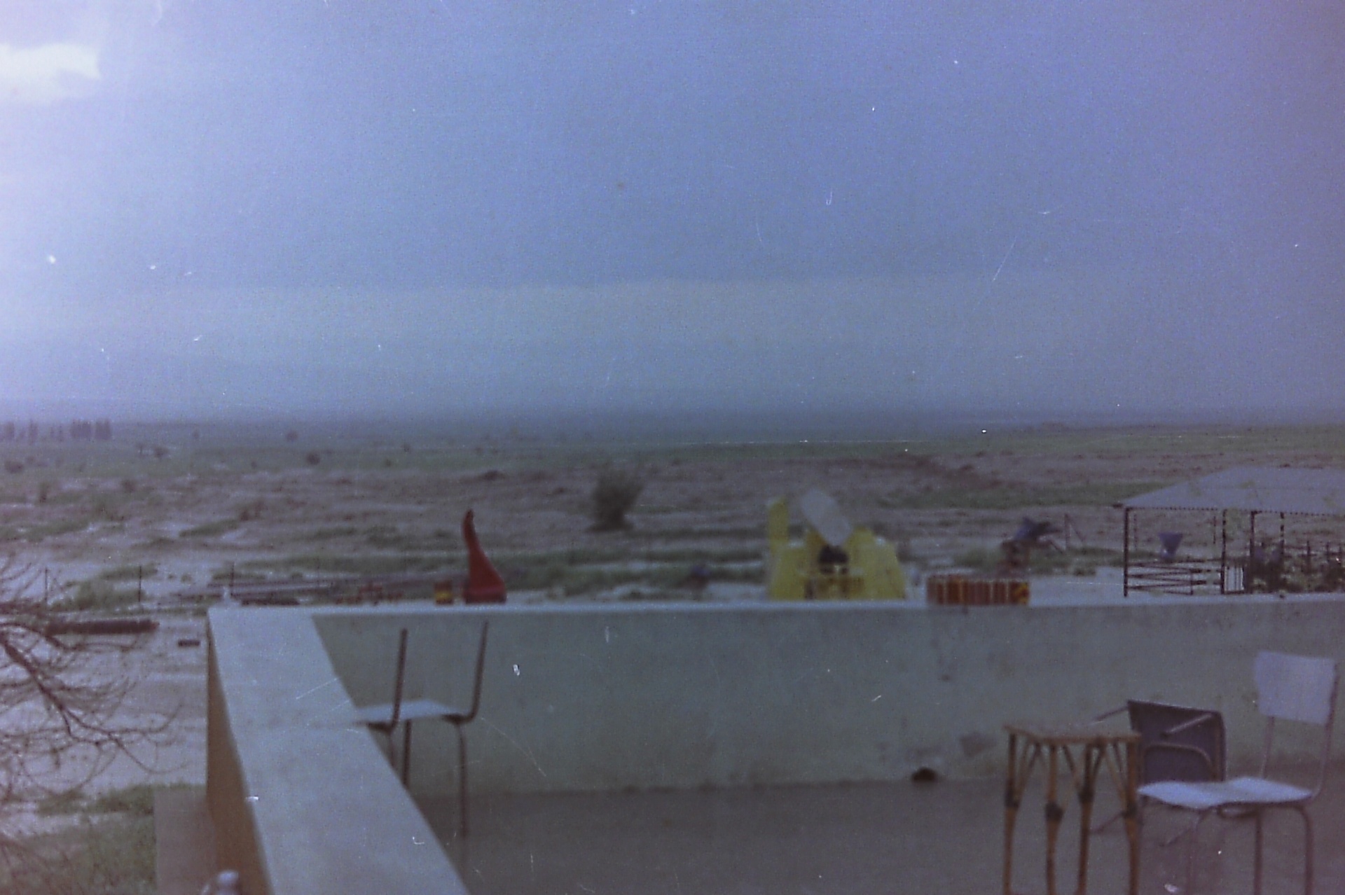 Fasayel landscape during the years of hard work — the New Holland combine resting in the fields, 1960s–70s.