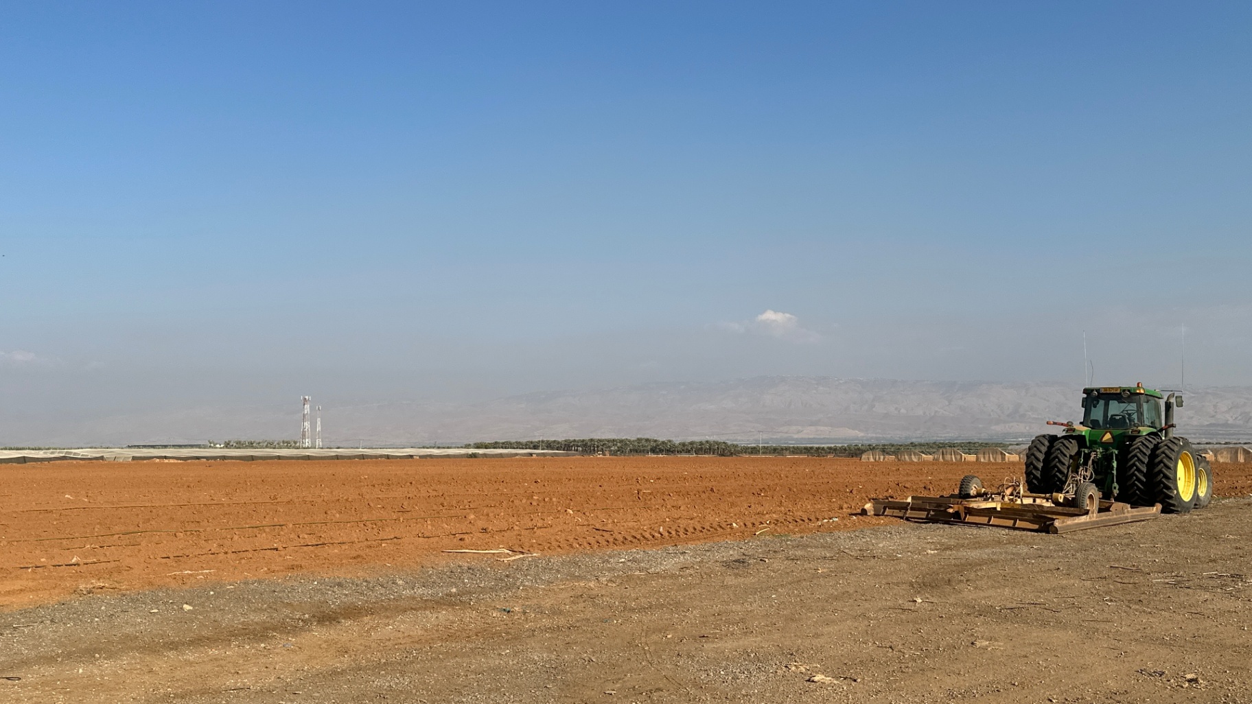 Land prep — the John Deere with the grader smoothing a field for the next planting.