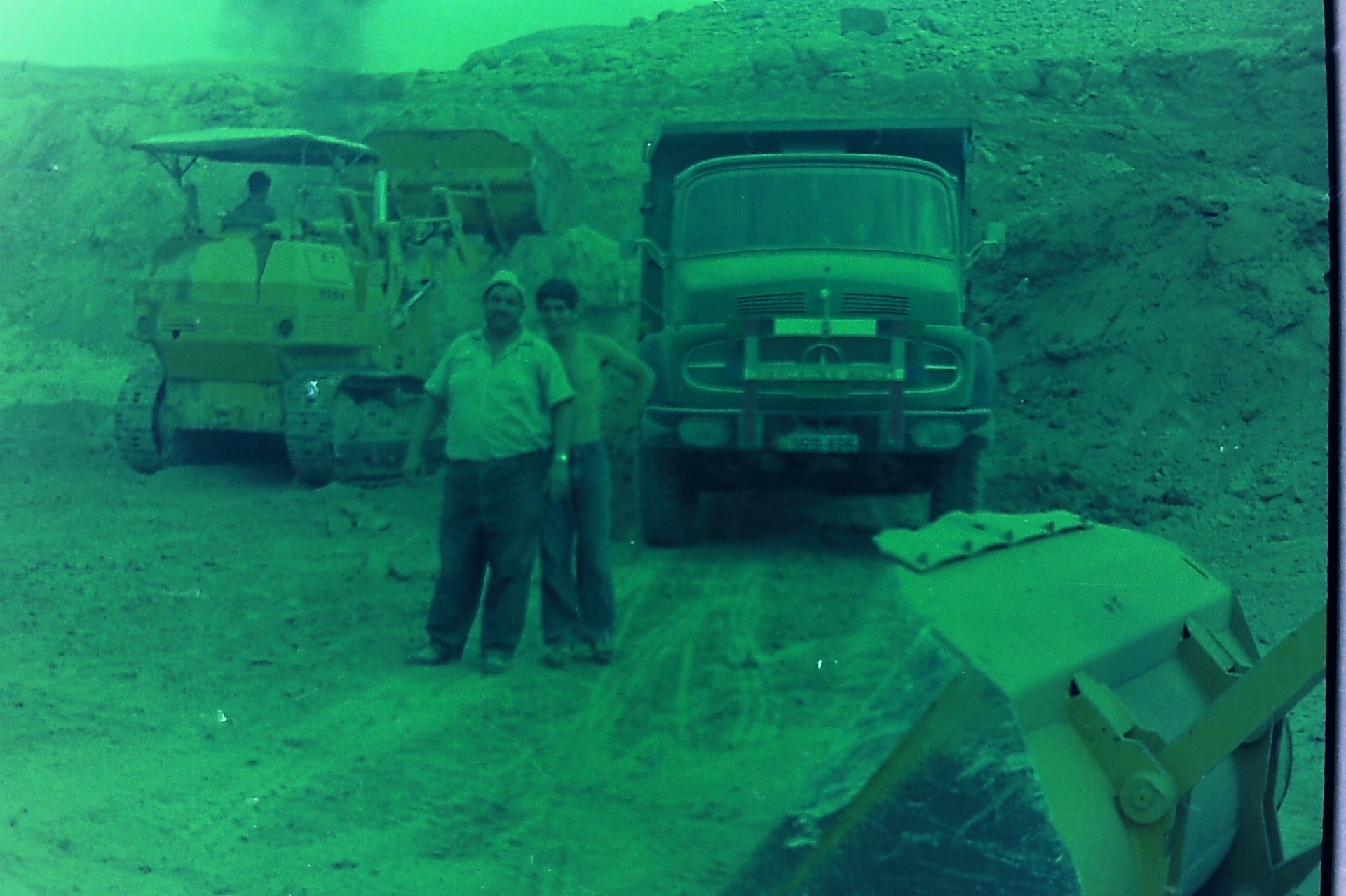 Roman Pool excavation — bulldozer, dump truck and crew in the dust.