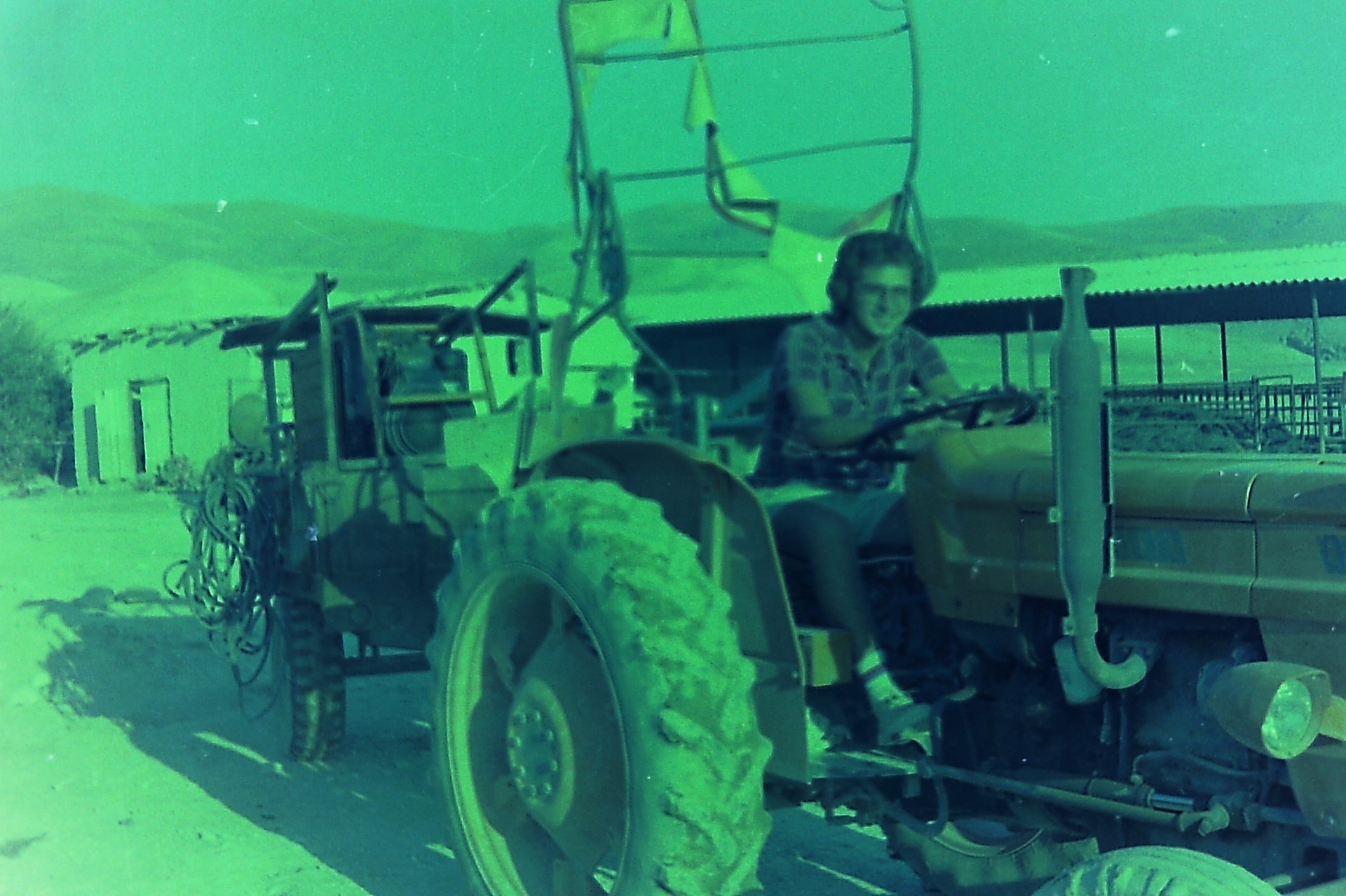 Saad Al-Nimer at the wheel of the tractor, hauling pipe during the pipeline project.