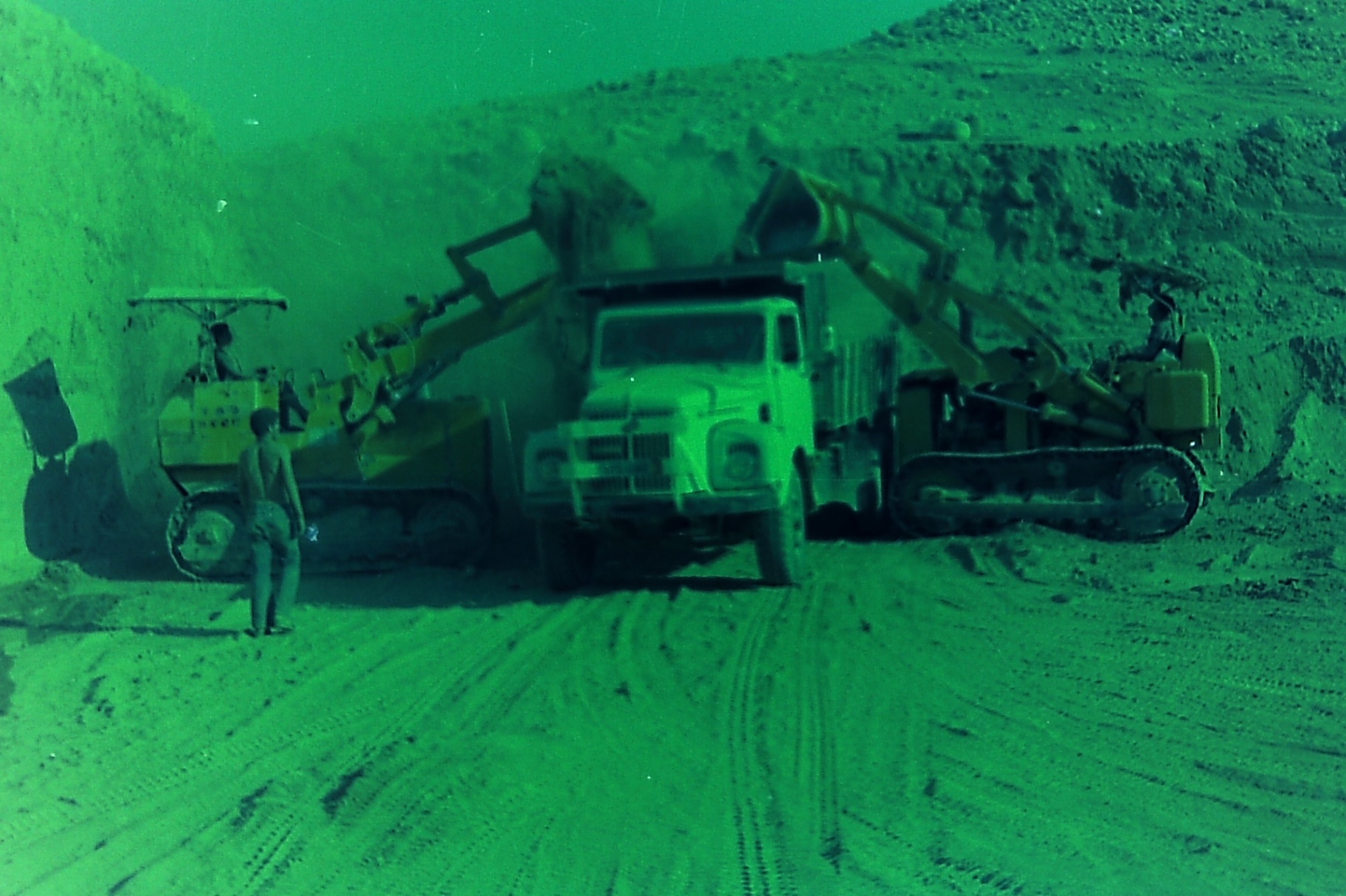 Loaders and a dump truck working the Roman Pool excavation site.