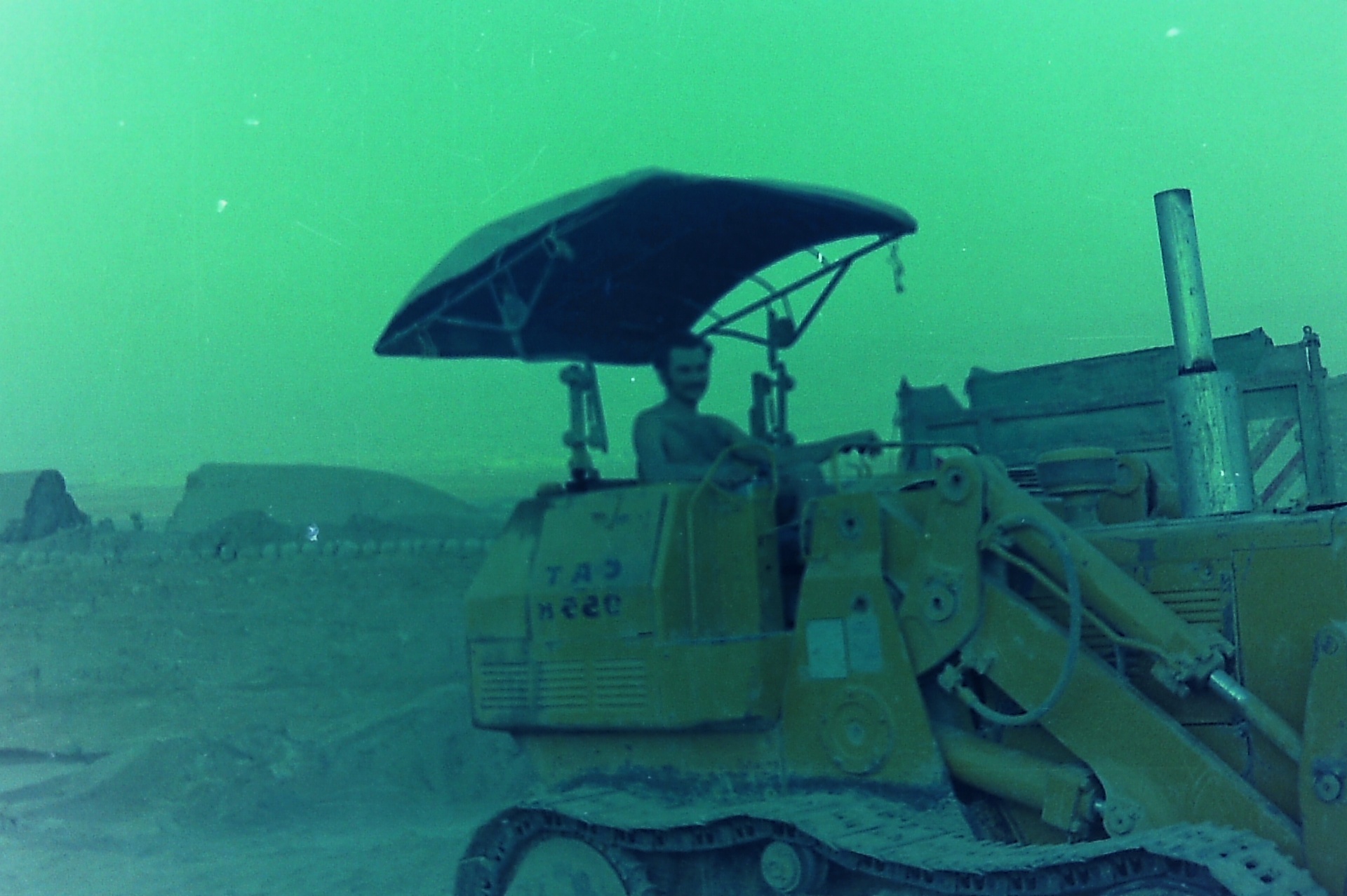 Samsam Al-Nimer at the controls of the CAT bulldozer during the Roman Pool excavation.